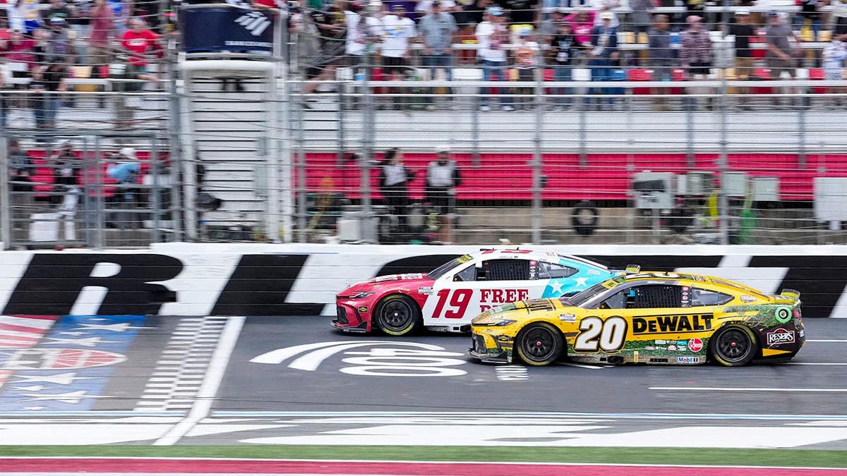 Chase Briscoe in car number 19 races against Christopher Bell in car number 20 at Charlotte Motor Speedway.