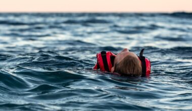 girl in cold water with red lifevest