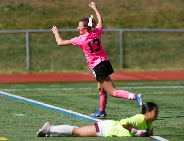 Medfield's Sidney Heavey, top, celebrates after scoring her third goal of the match against Concord-Carlisle goalkeeper Sally Wu, bottom, during the second half of a soccer game Oct. 10, 2026, in Medfield. (Paul Connors/Media News Group/Boston Herald)