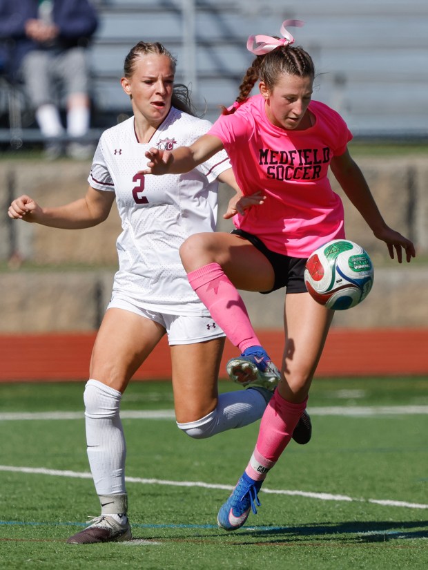 Medfield's Sidney Heavey, right, traps a pass in front of Concord-Carlisle's Teagan Graham, left, during the first half of a soccer match Oct. 10, 2026, in Medfield. (Paul Connors/Media News Group/Boston Herald)