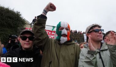 Drumcree: Kneecap visit Garvaghy Road to show support for residents - BBC