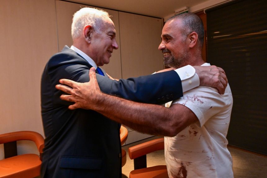 Israeli Prime Minister Benjamin Netanyahu greets passenger Yaniv Hayoun.