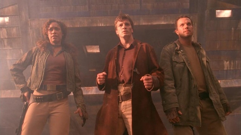 Gina Torres as Zoë Washburne, Nathan Fillion as Captain Malcolm Reynolds, and Adam Baldwin as Jayne Cobb
