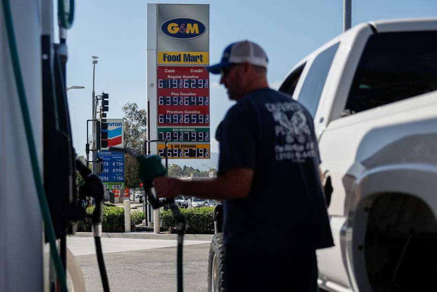 A sign displays the prices of unleaded gasoline and diesel fuel as a driver refuels a vehicle at a gas station in Torrance, California, on September 28, 2026.