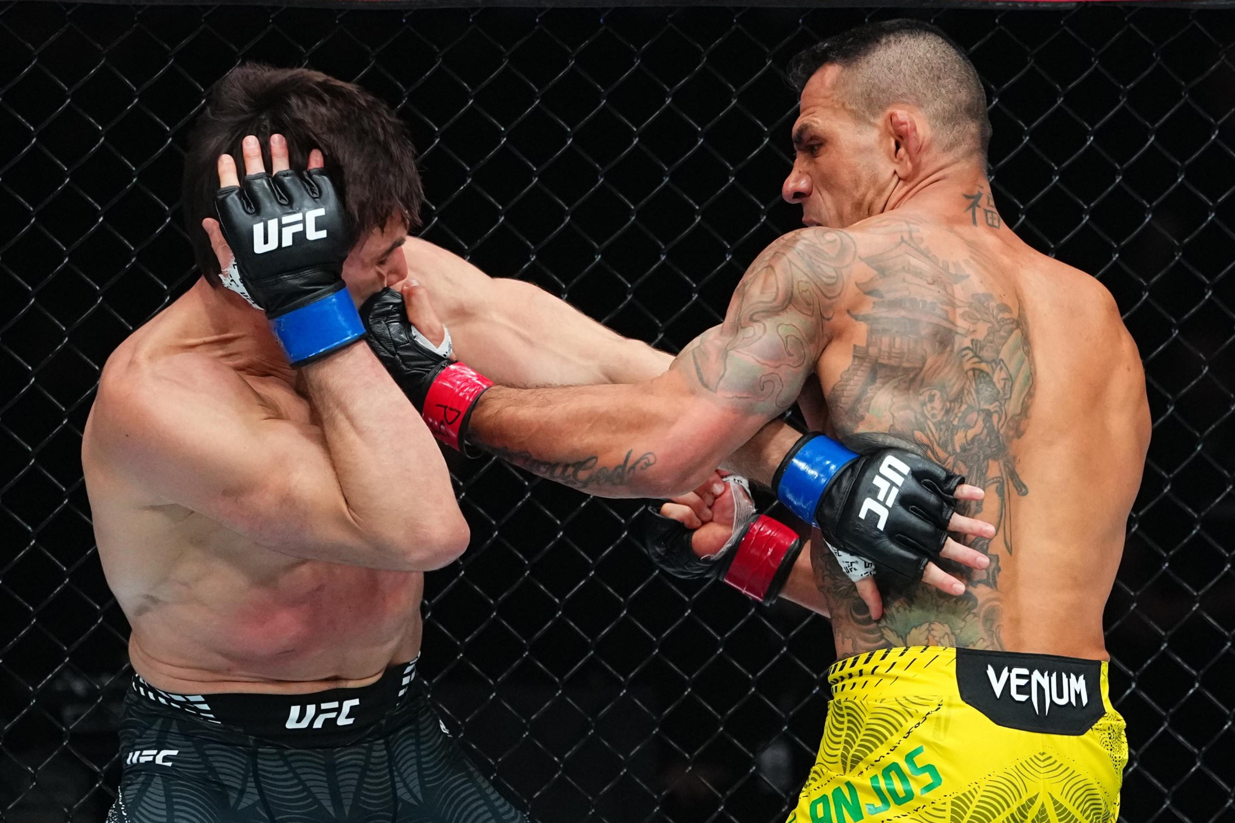 SALT LAKE CITY, UTAH - OCTOBER 03: Rafael Dos Anjos of Brazil punches Alexander Hernandez in a lightweight fight during the UFC 332 event at Delta Center on October 03, 2026 in Salt Lake City, Utah. (Photo by Jeff Bottari/Zuffa LLC)