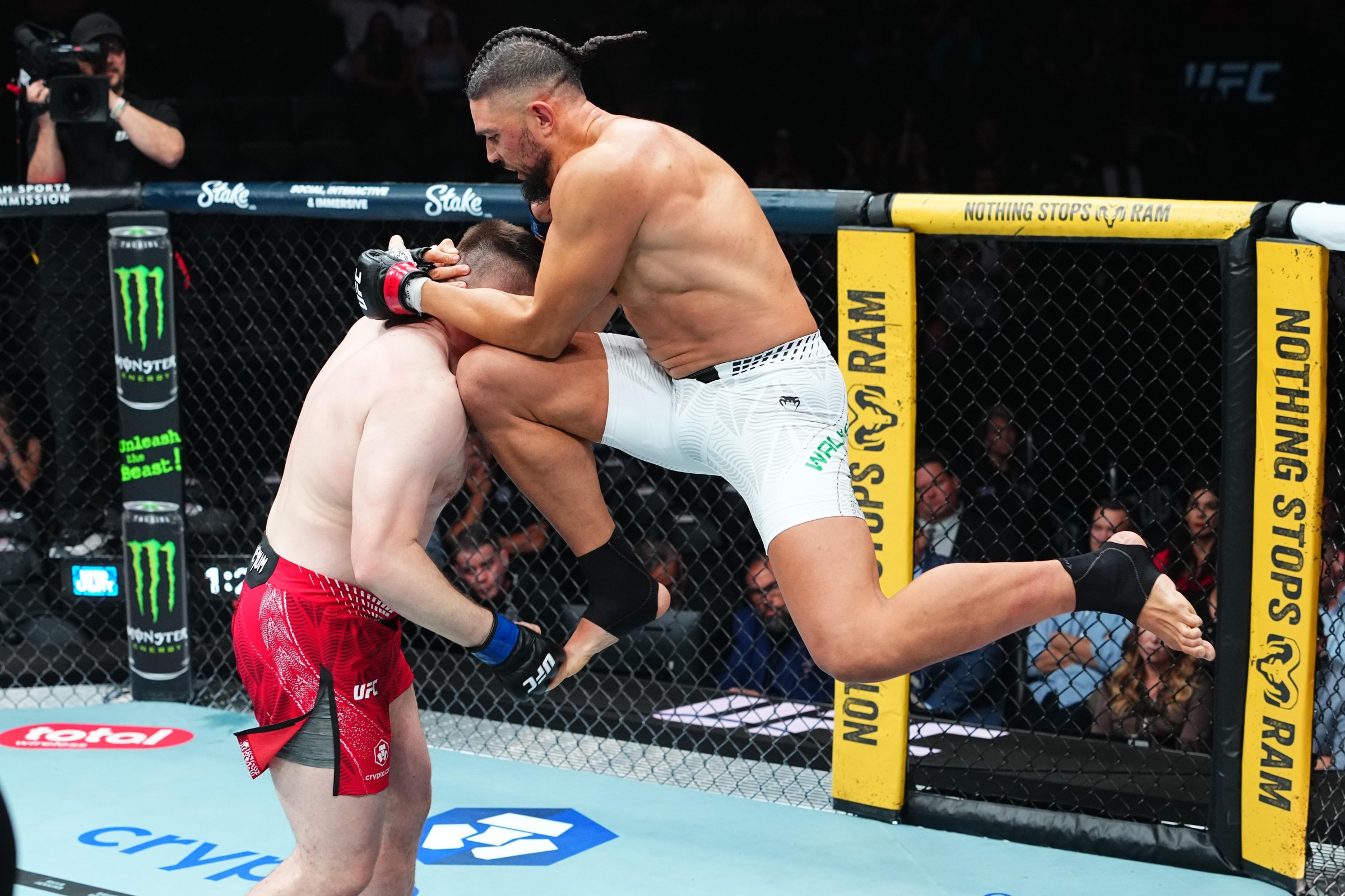 SALT LAKE CITY, UTAH - OCTOBER 03: Johnny Walker of Brazil knees Mick Parkin of England in a heavyweight fight during the UFC 332 event at Delta Center on October 03, 2026 in Salt Lake City, Utah. (Photo by Jeff Bottari/Zuffa LLC)