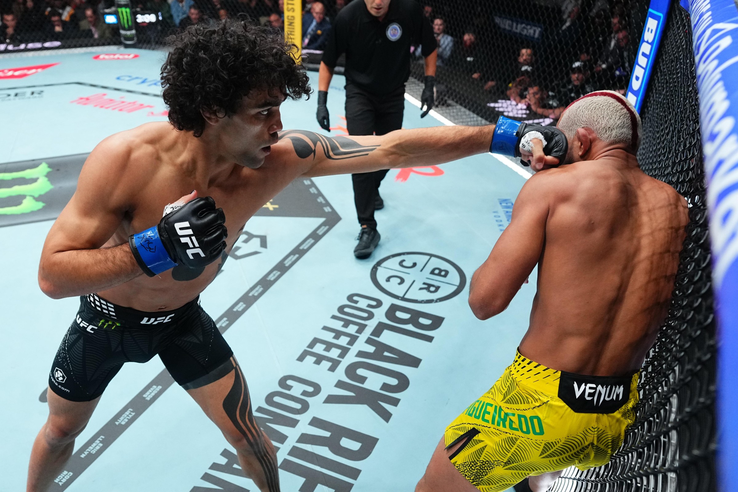 SALT LAKE CITY, UTAH - OCTOBER 03: Payton Talbott punches Deiveson Figueiredo of Brazil in a bantamweight fight during the UFC 332 event at Delta Center on October 03, 2026 in Salt Lake City, Utah. (Photo by Jeff Bottari/Zuffa LLC)
