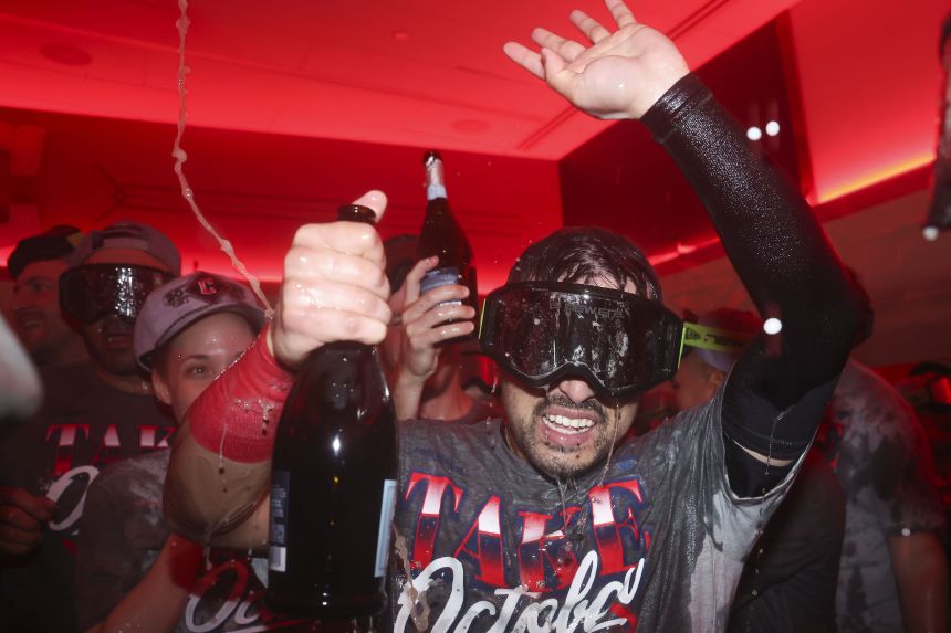 The Cleveland Guardians' Steven Kwan celebrates in the clubhouse after defeating the Chicago White Sox to advance to the American League Championship Series.