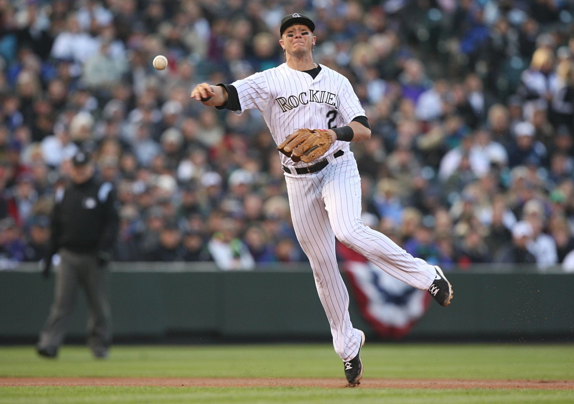 DENVER - OCTOBER 11: Troy Tulowitzki #2 of the Colorado Rockies throws out Pedro Feliz of the Philadelphia Phillies in the top of the fourth inning in Game Four of the NLDS during the 2009 MLB Playoffs at Coors Field on October 12, 2009 in Denver, Colorado. (Photo by Jed Jacobsohn/Getty Images)