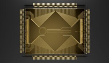 Image of a grey square with lots of wires heading into a gold chip with a complicated arrangement of channels on its surface.