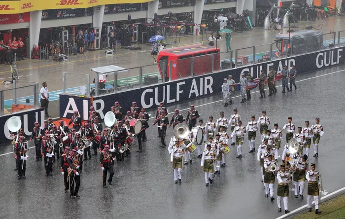 Marching bands perform on the grid.
