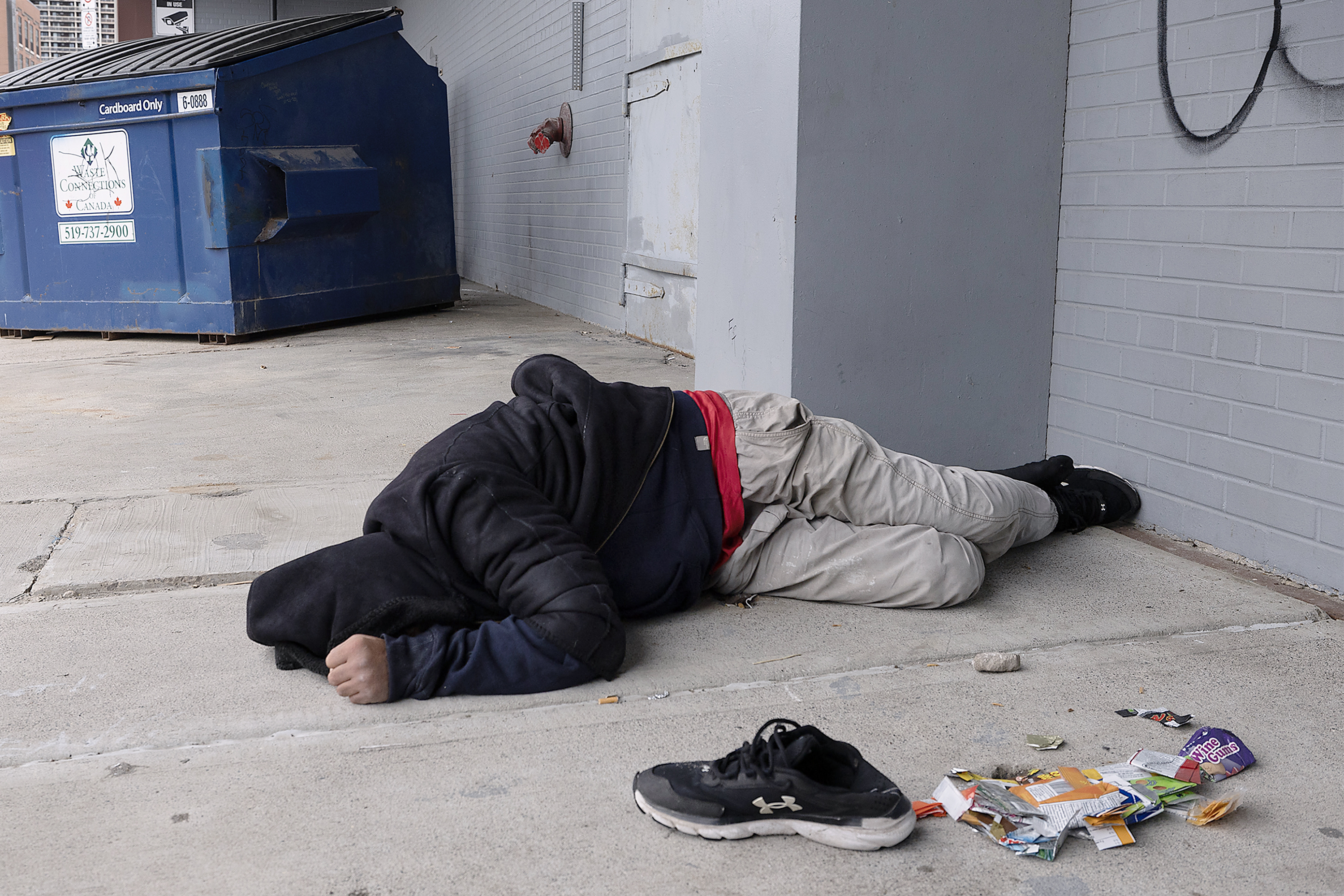 A man sleeps on Pelissier Street in downtown Windsor