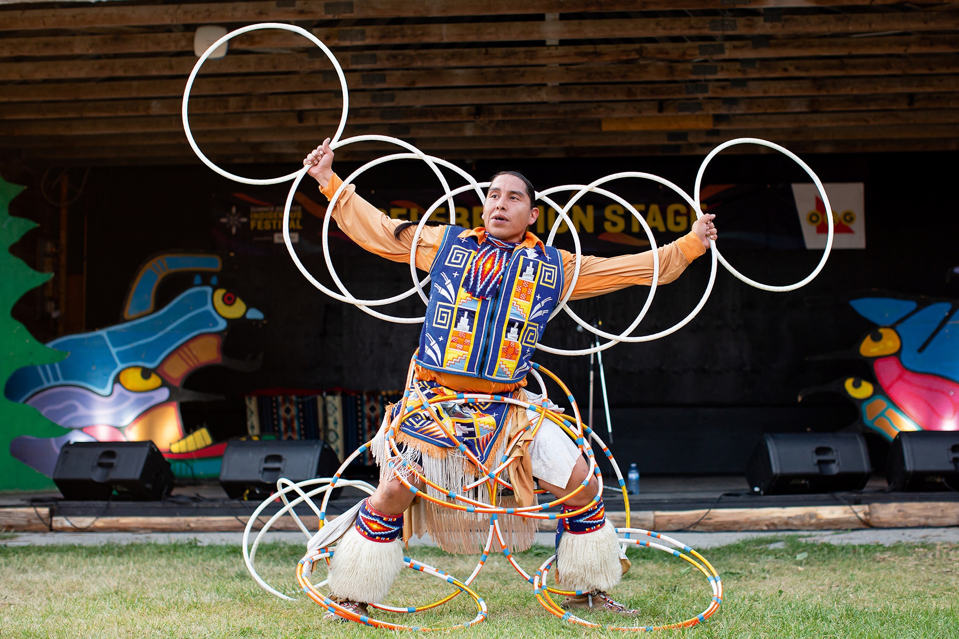 Indigenous hoop dancer, with hoops on arms, legs and waist