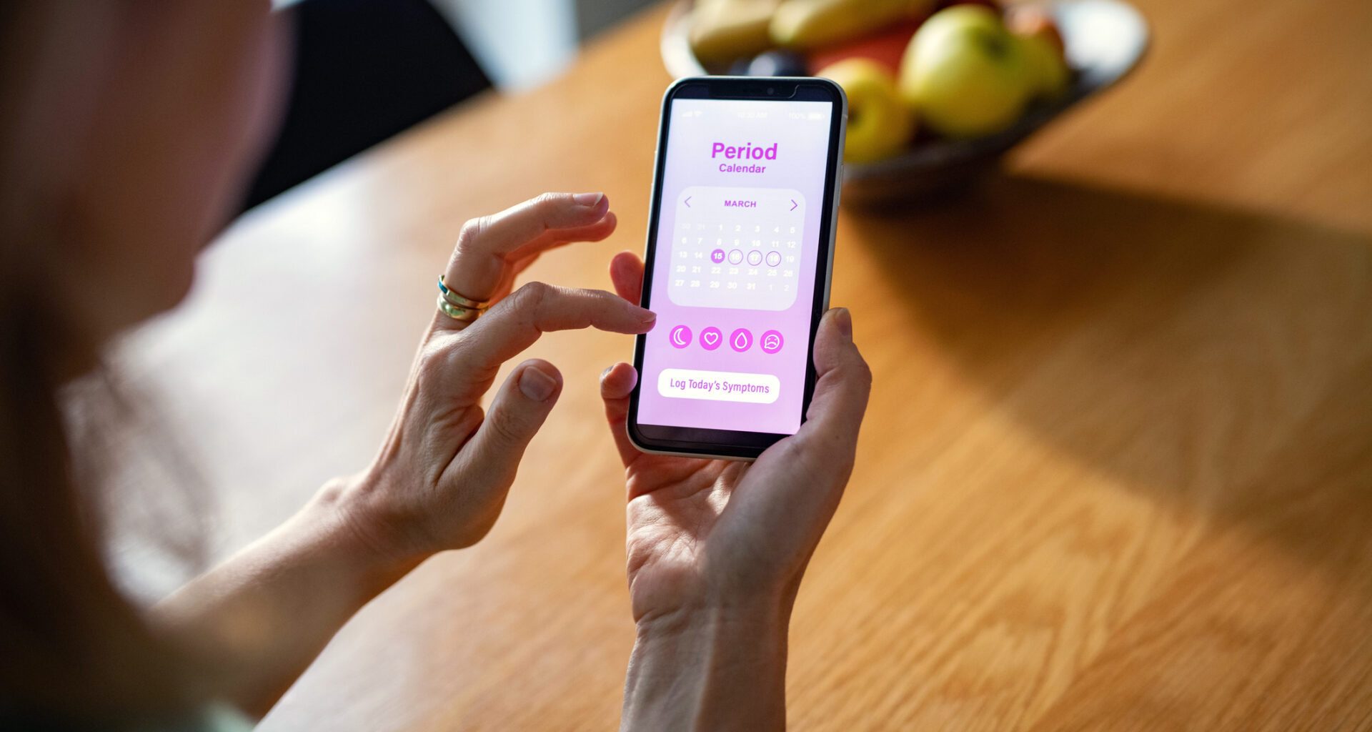 A person tracking their period on an app on their smartphone.