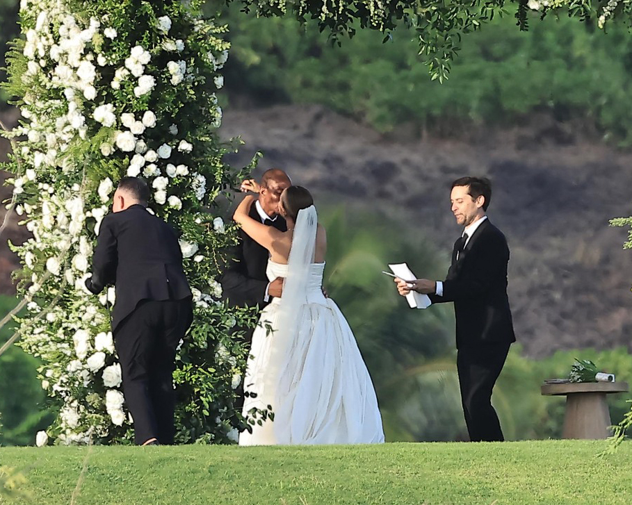 Jennifer Meyer and Geoff Ogunlesi embrace at their wedding ceremony, officiated by Tobey Maguire.