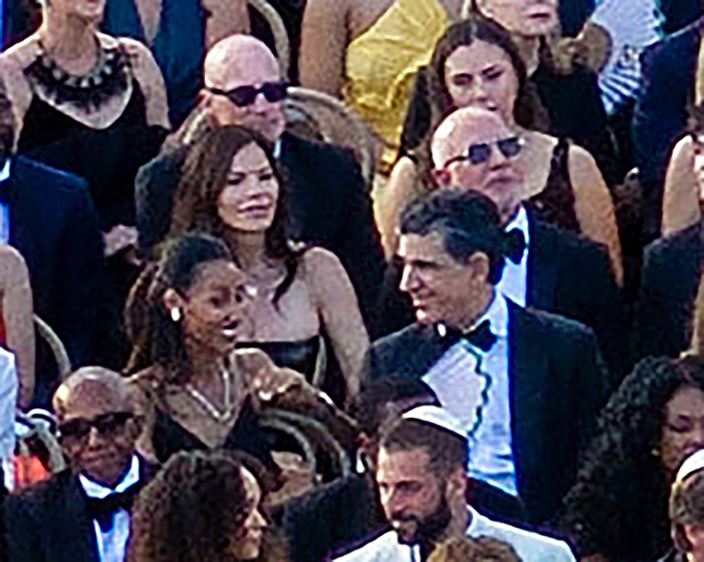 Jeff Bezos and Lauren Sanchez sitting among a crowd of guests.