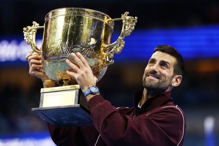 Tennis - China Open - National Tennis Center, Beijing, China - October 6, 2026 Serbia's Novak Djokovic celebrates with the trophy after winning the final against Australia's Alex de Minaur REUTERS/Tingshu Wang