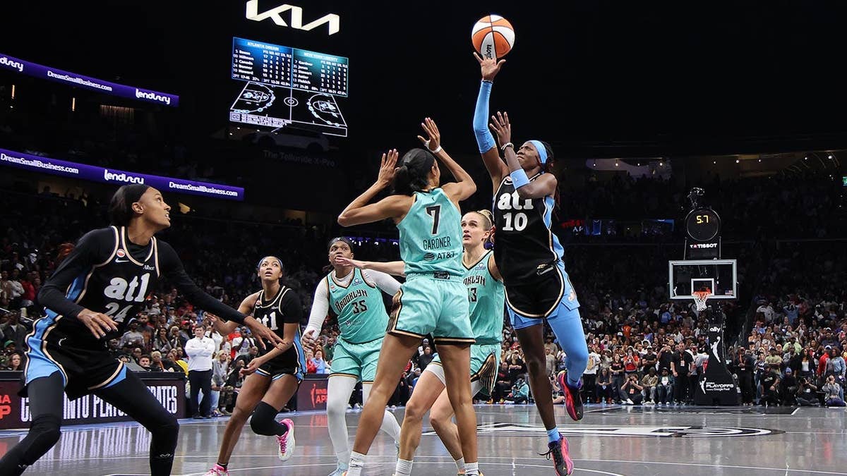 Rhyne Howard shoots over Rebekah Gardner during WNBA playoffs game at State Farm Arena.