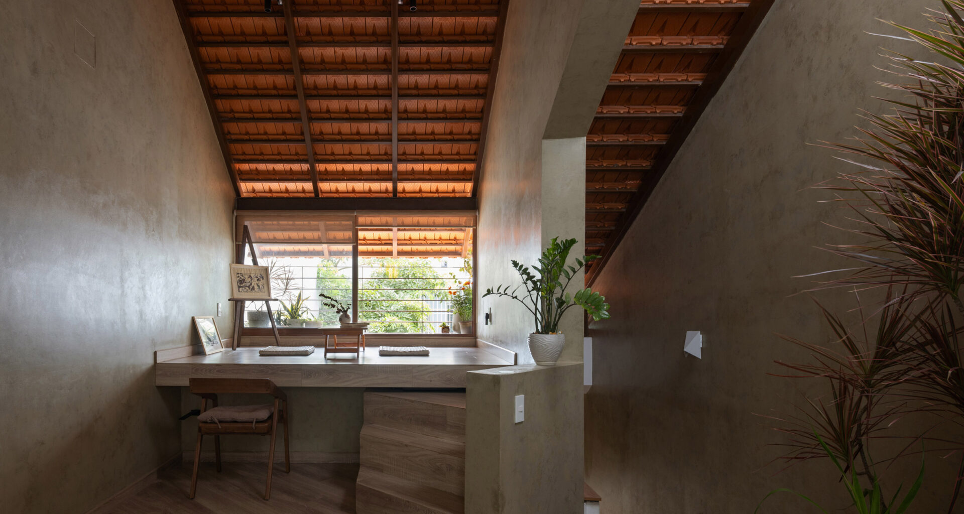 Terracotta tiles enclose skinny Roof House in Vietnam