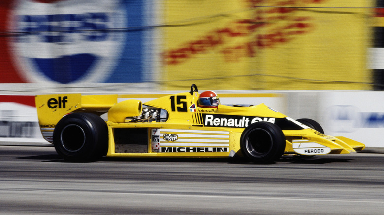 Side view of yellow Renault RS01 Formula 1 car racing at Long Beach in the 1970s.