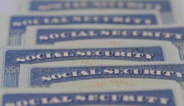 Close-up of overlapping U.S. Social Security cards arranged in rows