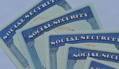 Several overlapping U.S. Social Security cards on a light background