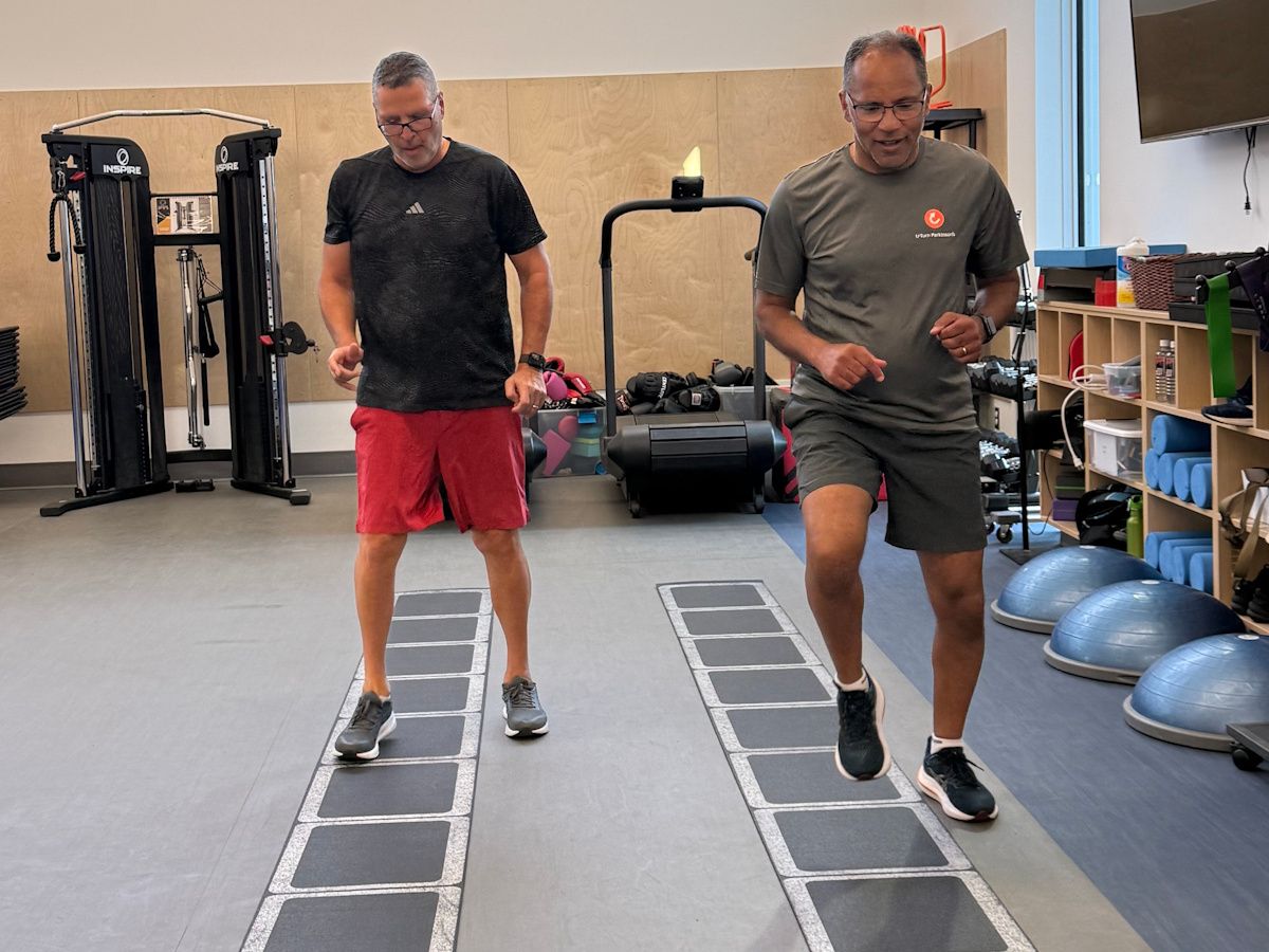 two men walking along indoor exercise path