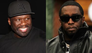 50 Cent wearing a black cap and a "Vuitton" shirt, holding a microphone, with a food platter in the background.