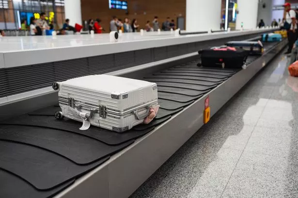 Baggage bags or suitcases on a conveyor belt at the global airport.