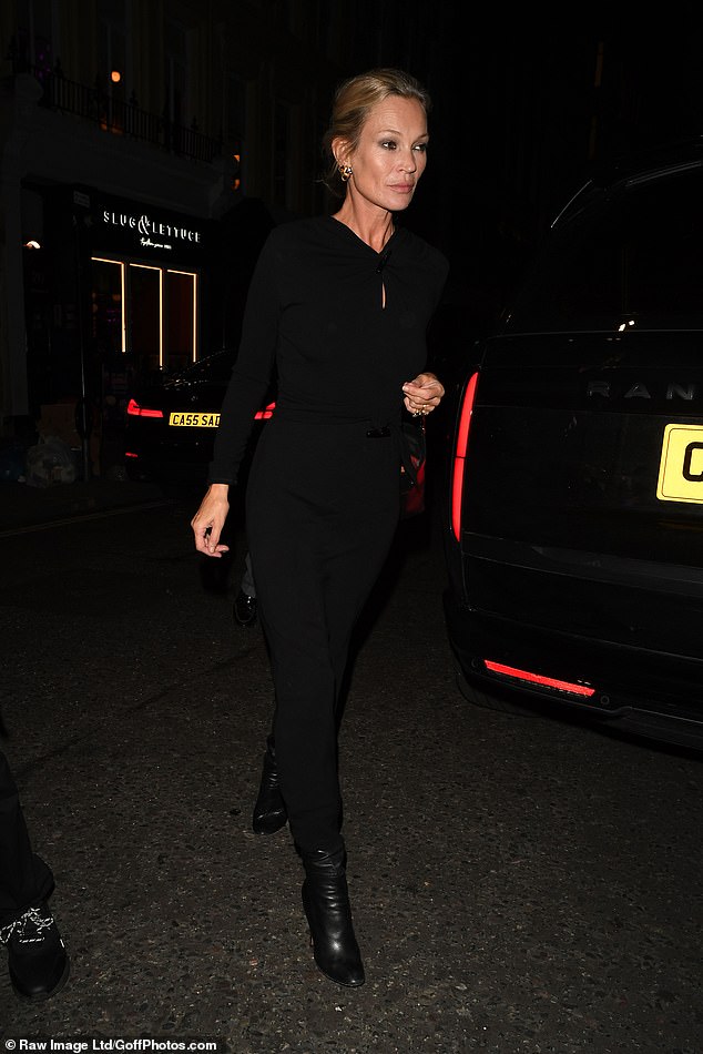 Kate looked effortlessly chic in a black dress with a keyhole cut out on the chest and long sleeves. She teamed the garment with heeled leather boots that gave her model frame a boost