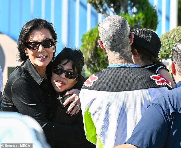 Joining Kardashian and Barker was her momager Kris Jenner (L), whom she affectionately embraced before enjoying the It's a Small World and The Little Mermaid rides