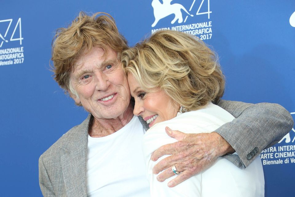 FILE - Actors Robert Redford and Jane Fonda hug as they pose for photographers at the photo call of the film "Our Souls at Night" during the 74th edition of the Venice Film Festival in Venice, Italy, on Sept. 1, 2017. (Photo by Joel Ryan/Invision/AP, File)