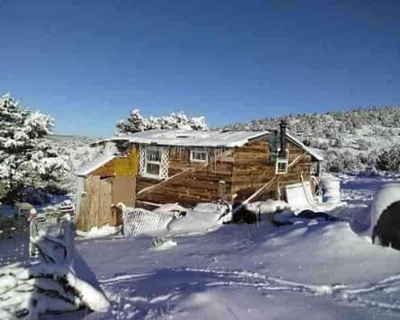 a small cabin in the snowy woods