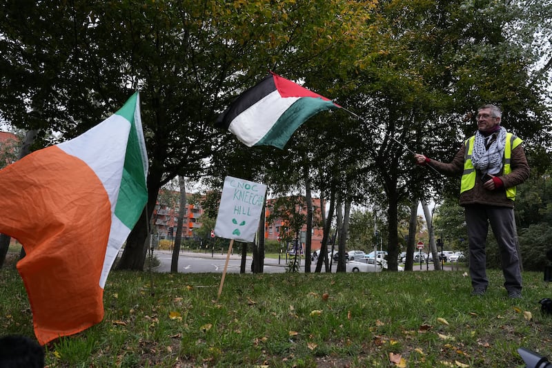 A supporters on "Cnoc Kneecap Hill" outside court on Friday. Photograph: Carlos Jasso/Getty