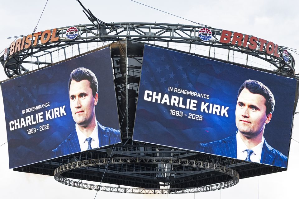 A tribute to Charlie Kirk is shown on large screens at a sporting event (Wade Payne/AP)