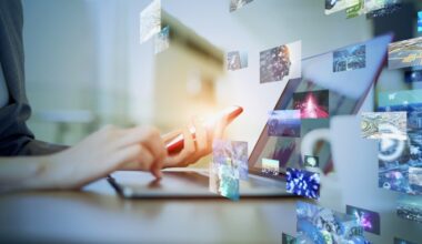 A person uses a smartphone and laptop surrounded by floating digital images,