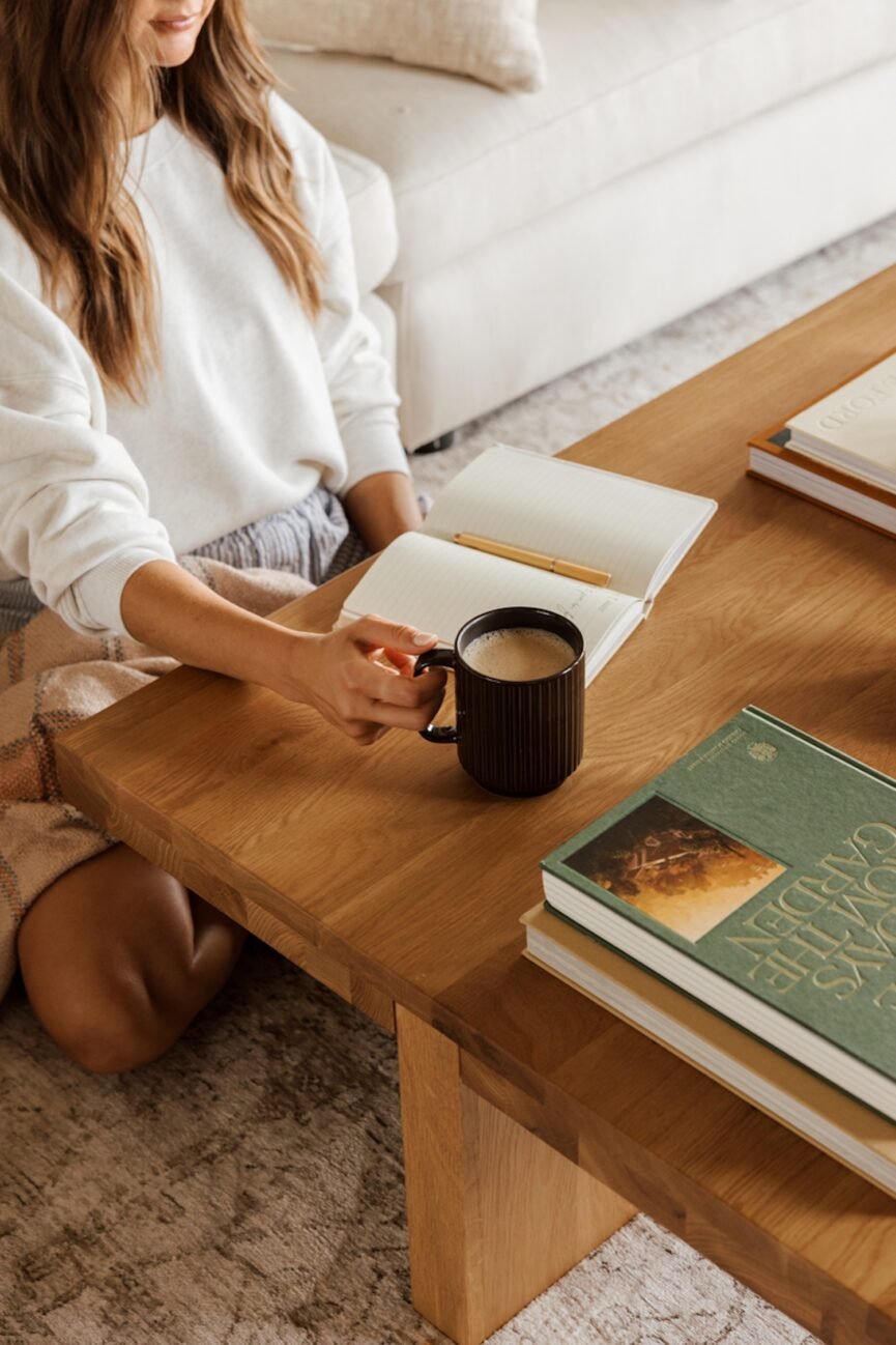 Woman drinking warm beverage practicing Ayurvedic rituals.