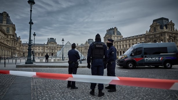 French police officers seal off the entrance to the Louvre Museum after a jewellery heist 