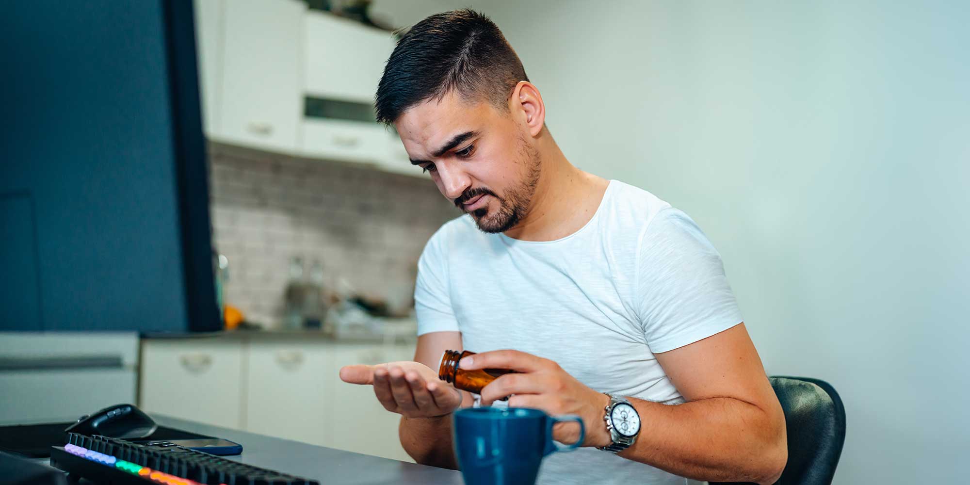A man measuring out a dose of supplements