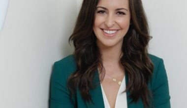 Jesse Draper headshot, in a green blazer