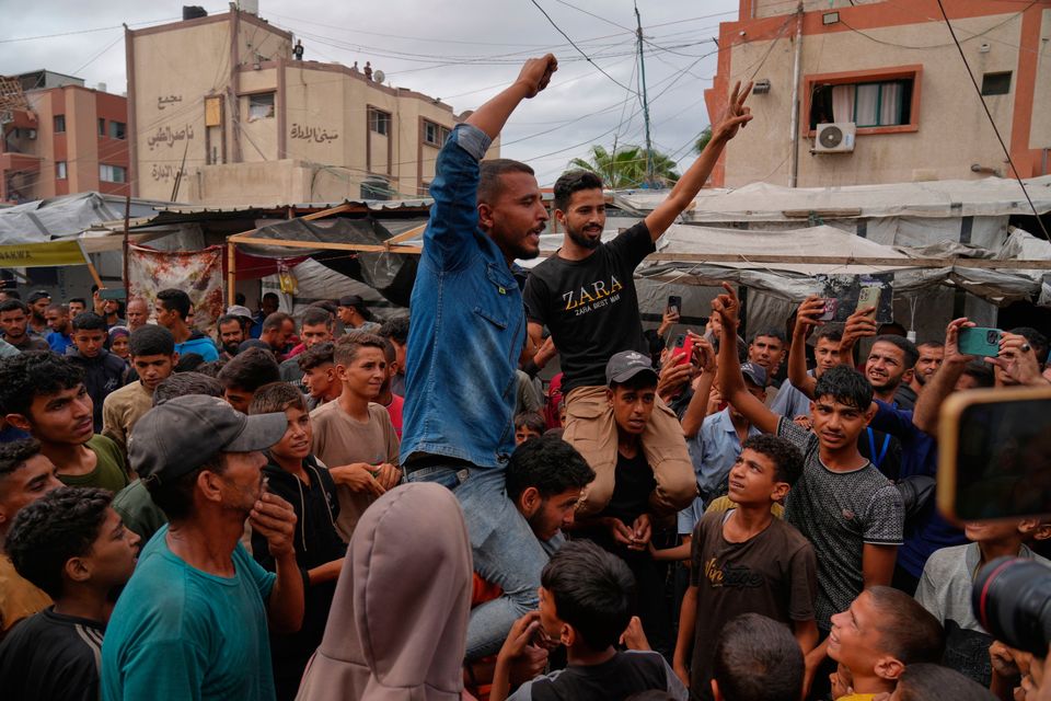 Palestinians In Khan Younis celebrate following the announcement that Israel and Hamas have agreed to the first phase of a peace plan. Photo: AP