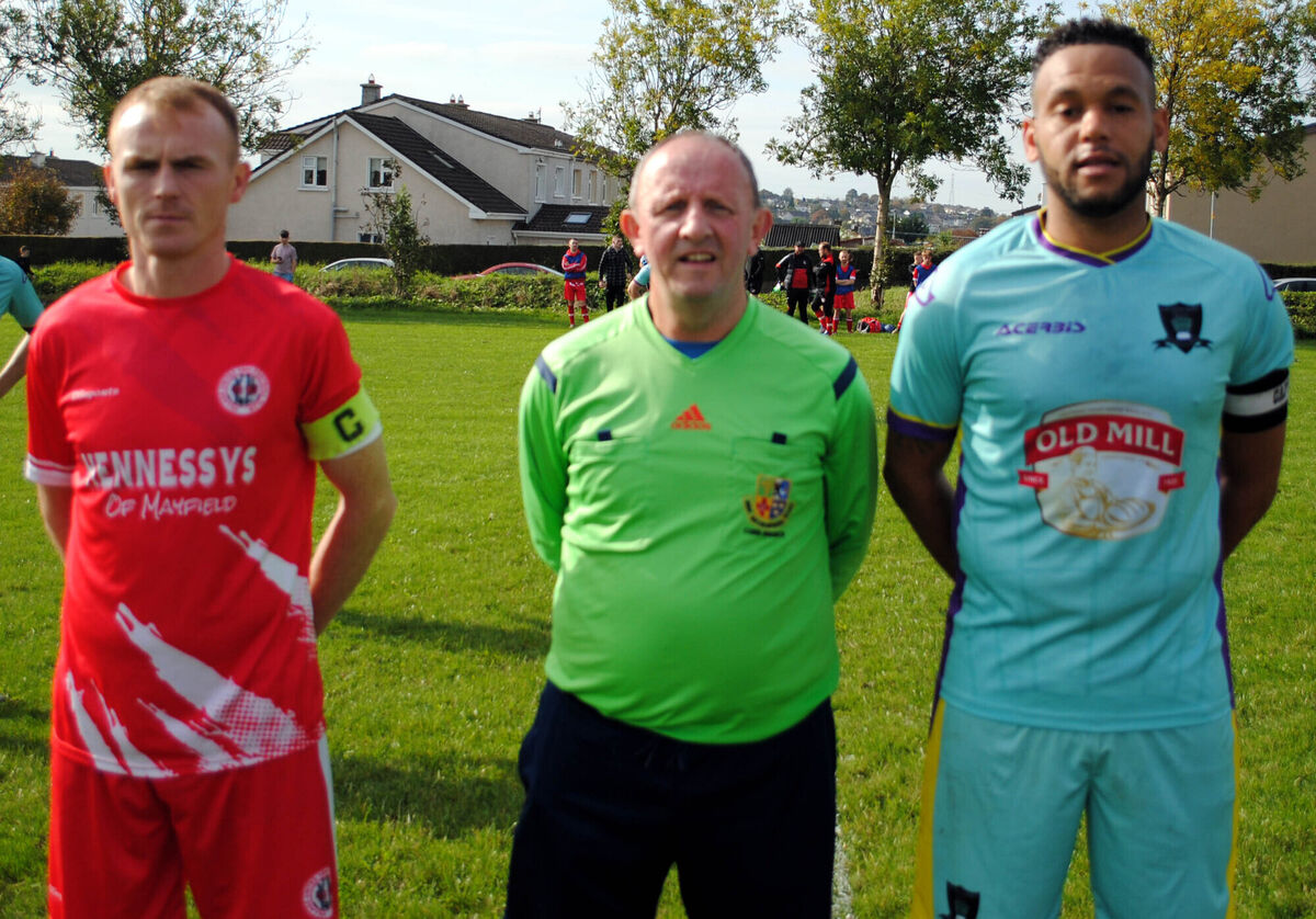 Village United captain Anthony Kiniry (left) with Knocknaheeny Celtic's Chris Akhigbe, accompanied by referee Paul Bowdren. Village United captain Anthony Kiniry (left) with Knocknaheeny Celtic's Chris Akhigbe, accompanied by referee Paul Bowdren.