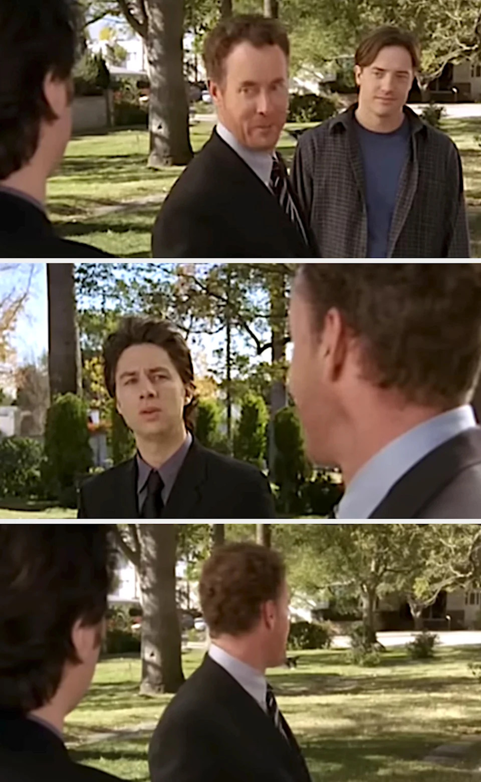 Two men in a park talking to another person, each wearing casual and formal attire, from a TV scene