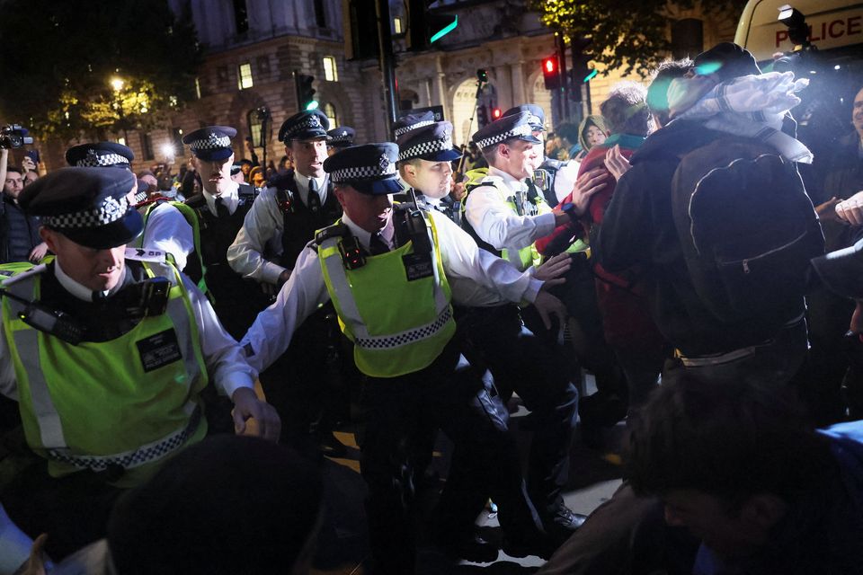 Police officers try to stop people marching in protest to demand protection for the Global Sumud Flotilla, some of whose vessels were intercepted by Israeli forces while carrying aid and activists to Gaza, in London, Britain, October 2, 2025. REUTERS/Jack Taylor