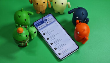 Android bots standing over a Pixel phone with various notifications