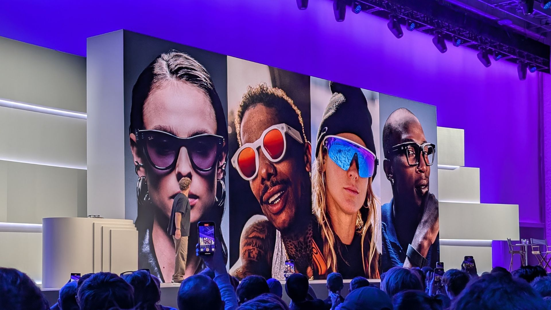 Meta CEO Mark Zuckerberg in front of a large visual showcasing the company's range of smart glasses
