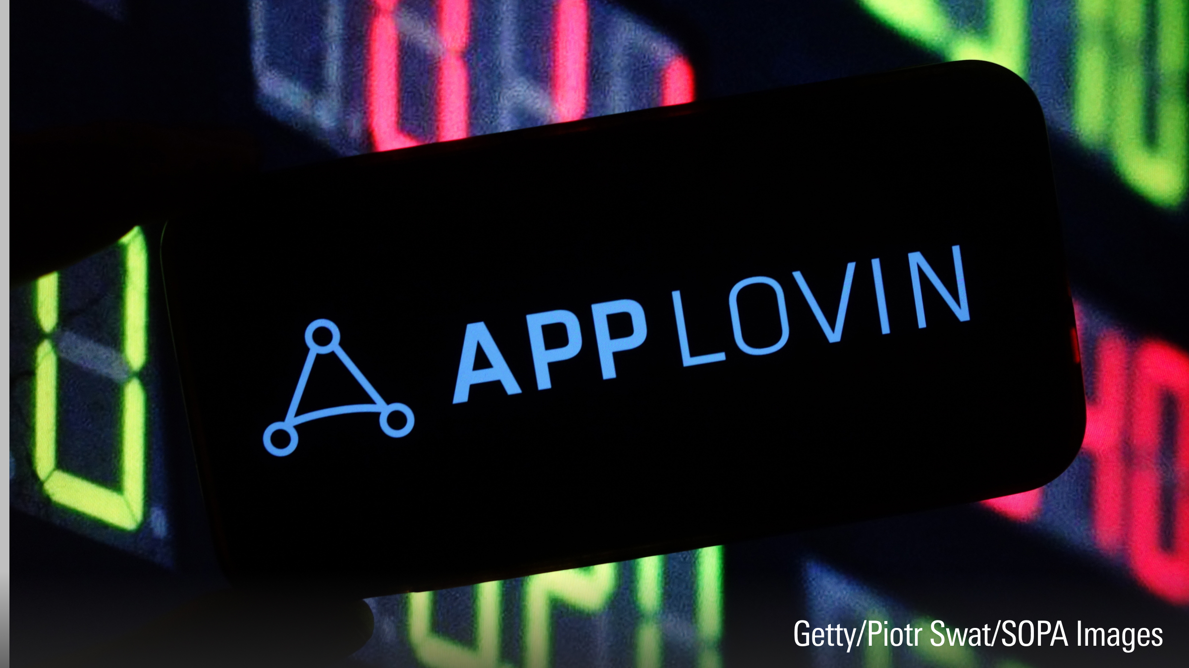 The AppLovin company logo is seen displayed on a smartphone screen