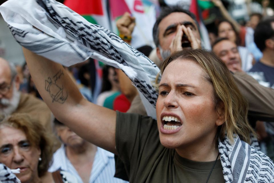 A woman reacts during a demonstration in front of Israeli embassy, after some of the vessels, including Portuguese citizens onboard, from the Global Sumud Flotilla, were intercepted by Israeli forces en route to Gaza, in Lisbon, Portugal, October 2, 2025. REUTERS/Pedro Rocha