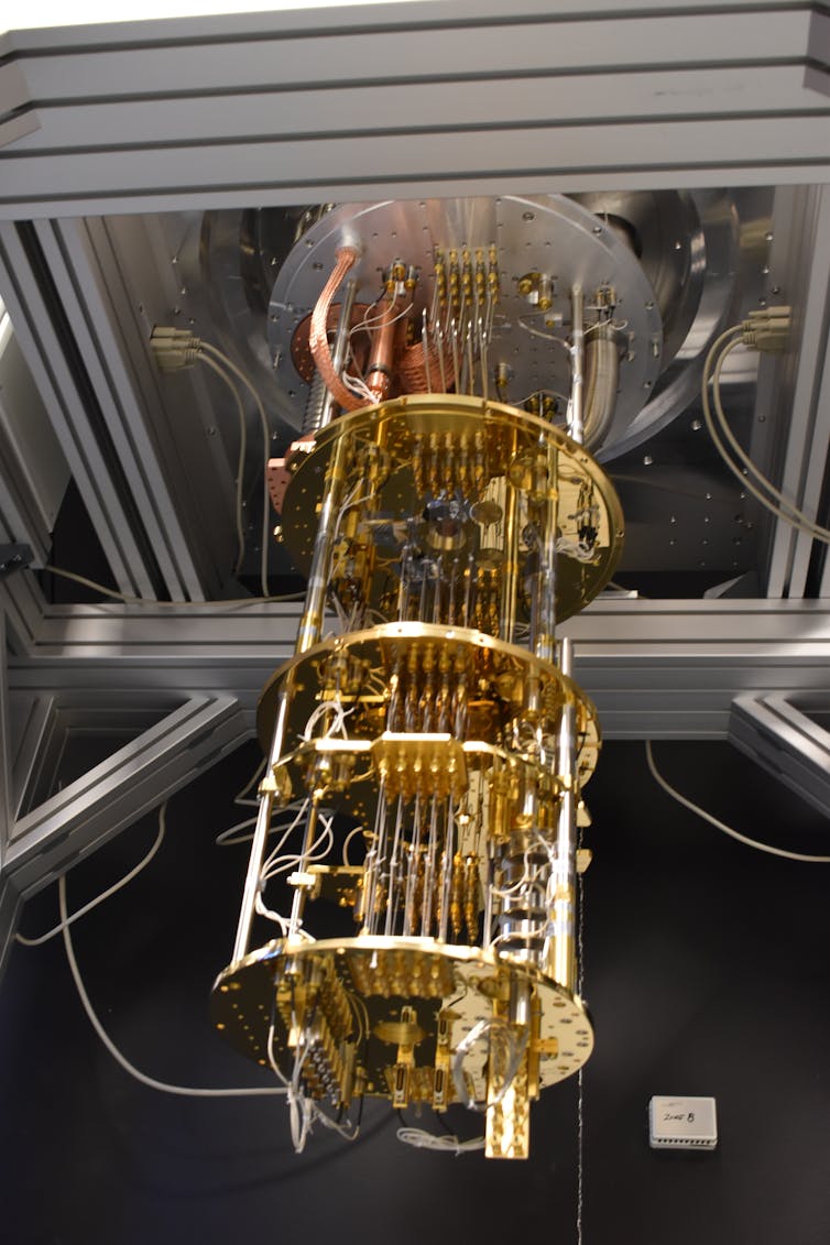 four parallel brass-colored rings connected by vertical tubes