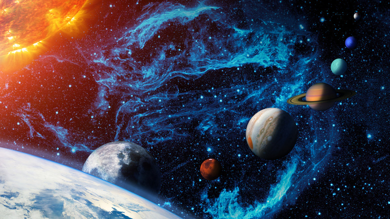 artistic image of the solar system with the sun, Earth, and the planets